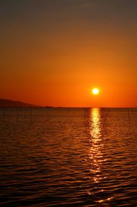 Scenic view of sea against orange sky