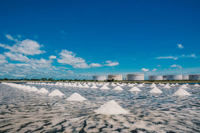 Scenic view of snow covered land against blue sky