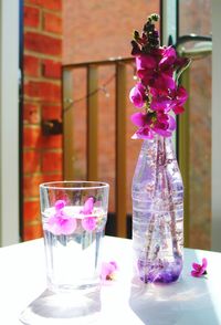 Flowers in glass vase on table