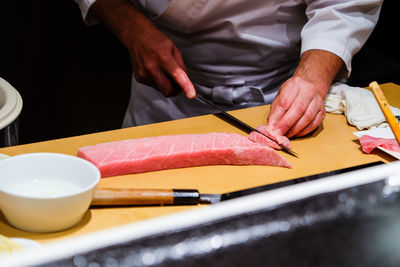 Midsection of man preparing food