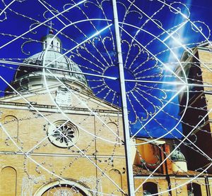 Low angle view of illuminated building against blue sky
