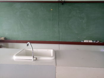 Close-up of faucet against wall