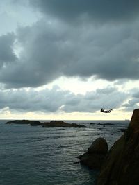 Scenic view of sea against cloudy sky