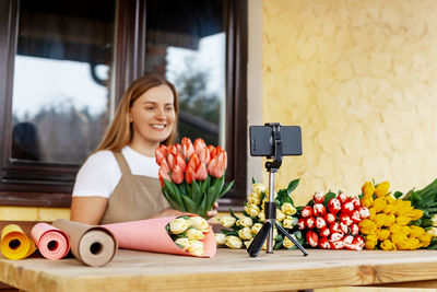 Close-up of the phone on which a woman is shooting a video for her blog, a florist girl 