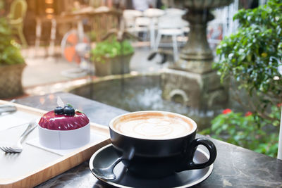 Close-up of coffee in cup on table at outdoor cafe