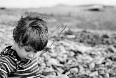 Cute boy playing stick