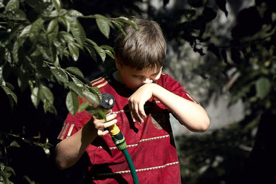 Close-up of boy holding umbrella