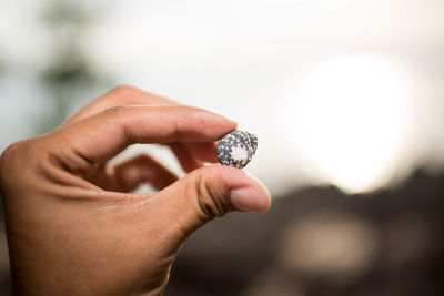 Close-up of human hand holding finger