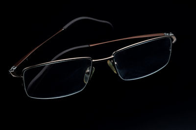 Close-up of sunglasses against black background