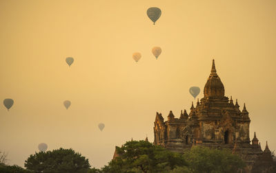 Hot air balloons against sky during sunset