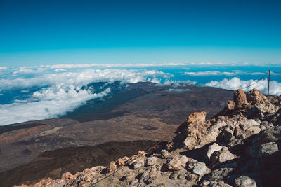 Scenic view of mountains against blue sky