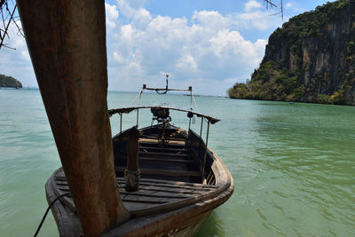 Boat moored on sea against sky