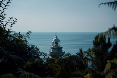 View of building by sea against clear sky