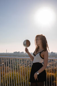 Woman standing on field against sky