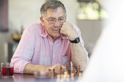 Senior couple playing chess at home