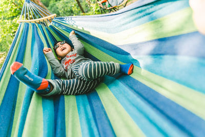 Low section of woman standing on hammock