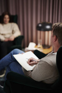 Male doctor and female patient at therapy session