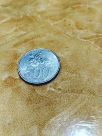 High angle view of coins on table