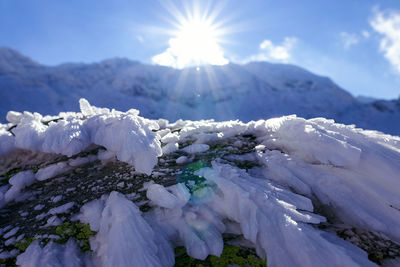 Scenic view of snow covered mountains against sky