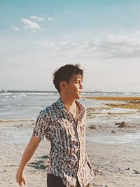 Man standing on beach against sea