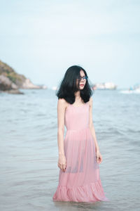 Young woman standing in sea