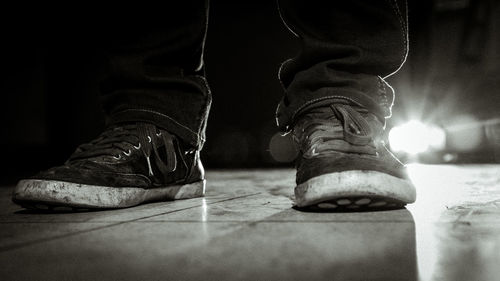 Low section of man wearing shoes