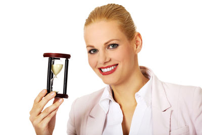 Portrait of a smiling young woman against white background