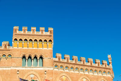 Low angle view of historical building against clear blue sky