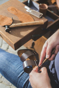 Close-up of shoemaker making sandal at workshop