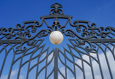 Low angle view of street light against blue sky