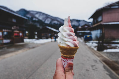 Cropped hand holding ice cream cone