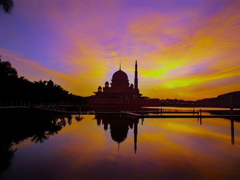 Reflection of mosque in lake during sunset