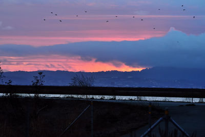 Scenic view of lake against sky at dusk