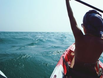 Rear view of woman on kayak at sea