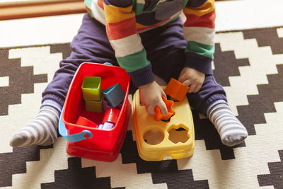 High angle view of boy playing with toy at home