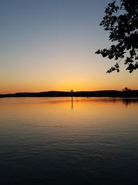 Scenic view of sea against clear sky during sunset