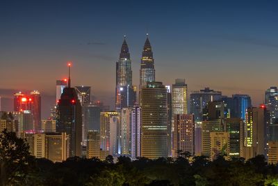 Illuminated buildings in city in the morning before the sunrise 