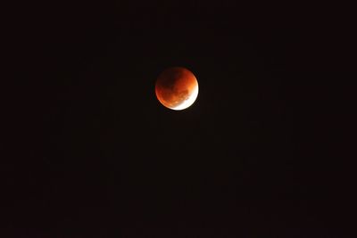 Low angle view of moon against clear sky at night