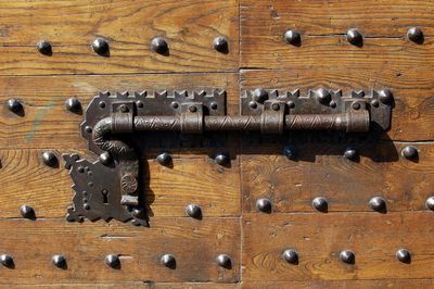 Close-up of knob on wooden door