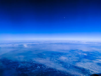 Aerial view of landscape against blue sky