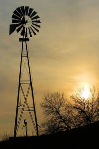 Low angle view of silhouette windmill against sky during sunset