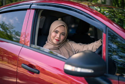 Portrait of woman sitting in car