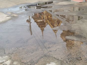 Reflection of building in puddle