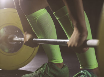 Close-up of woman preparing to lift barbell