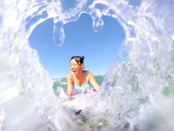 Smiling woman swimming in sea