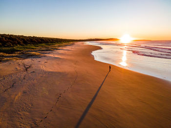 Scenic view of beach against sky during sunset