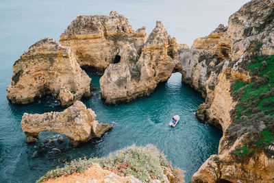 High angle view of rock formations in sea