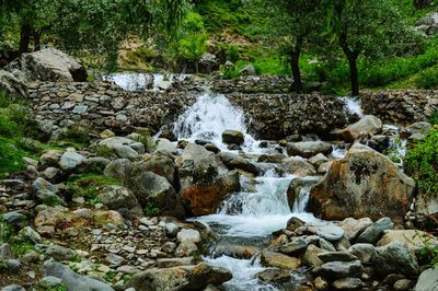 Stream flowing through rocks in forest