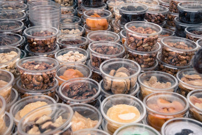 Close-up of dried fruit containers in market