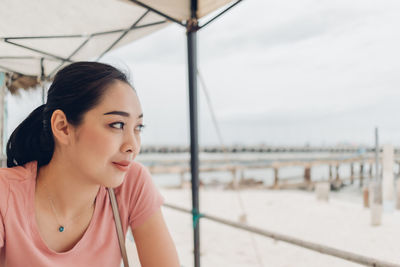 Portrait of happy young woman looking away